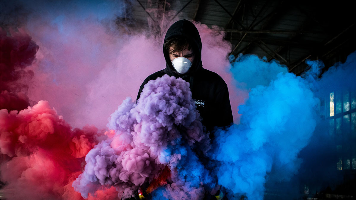 man in mask colorful smoke