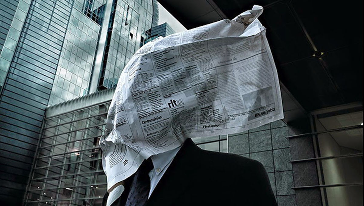 newspaper in face