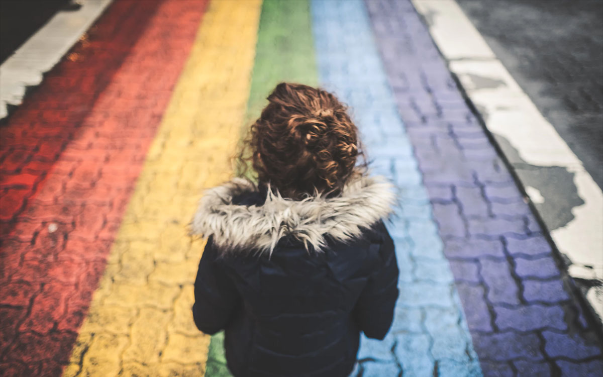 woman on rainbow road